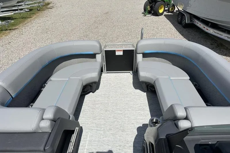 Slide: The Image of 2025 Bennington 22M pontoon boat interior with gray seating and blue accents. - 6