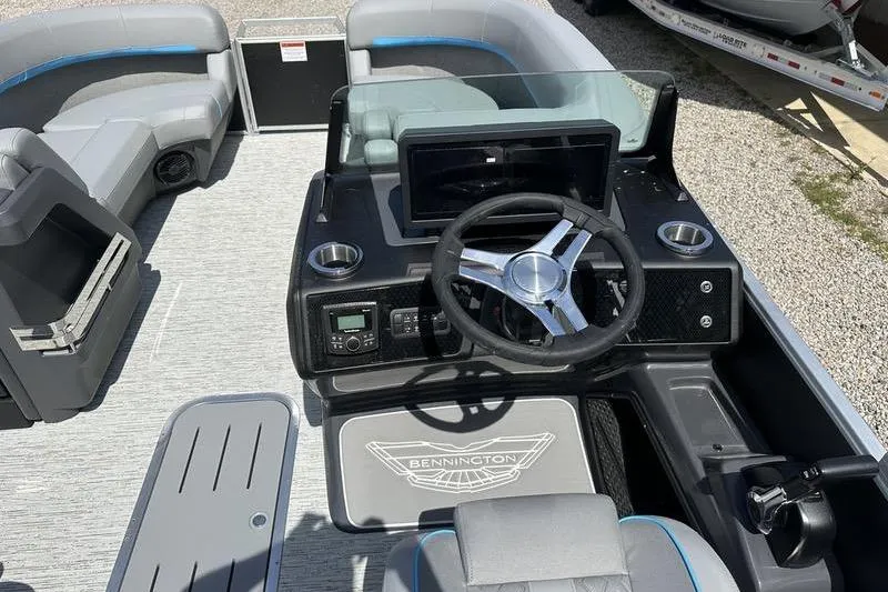 Slide: The Image of 2025 Bennington 22M boat dashboard with steering wheel and seating area. - 8