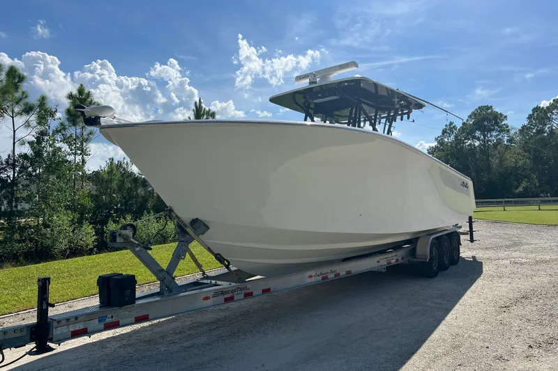 Slide: The Image of 2022 SeaHunter 33 Tournament boat on trailer under clear blue sky. - 12