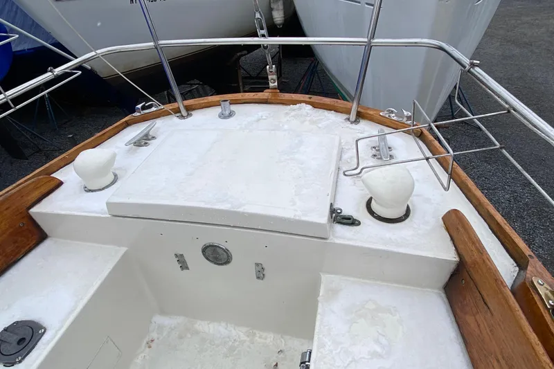 Slide: The Image of 1972 Bristol 40 sailboat deck with wooden trim and metal railings. - 10