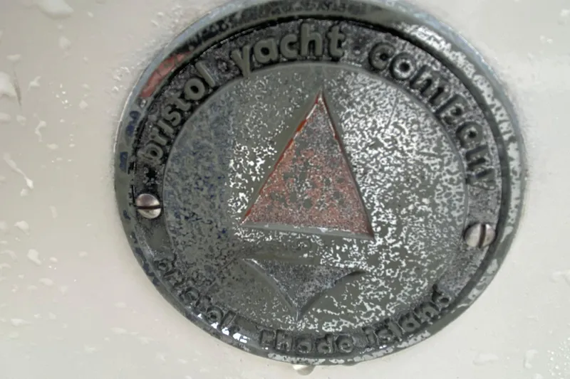 Slide: The Image of 1972 Bristol 40 yacht emblem with weathered finish and triangular design. - 12