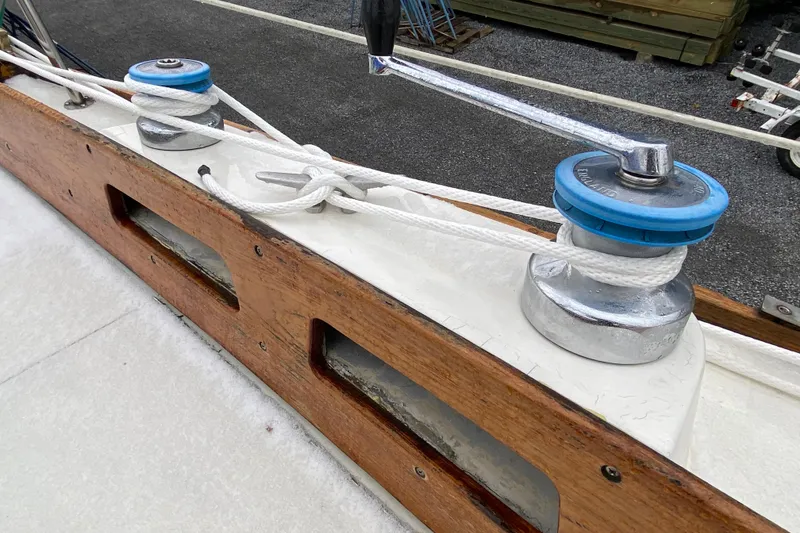 Slide: The Image of Winch and rope on 1972 Bristol 40 sailboat deck, featuring wooden trim. - 14