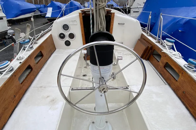 Slide: The Image of 1972 Bristol 40 sailboat cockpit with steering wheel and wooden accents. - 18