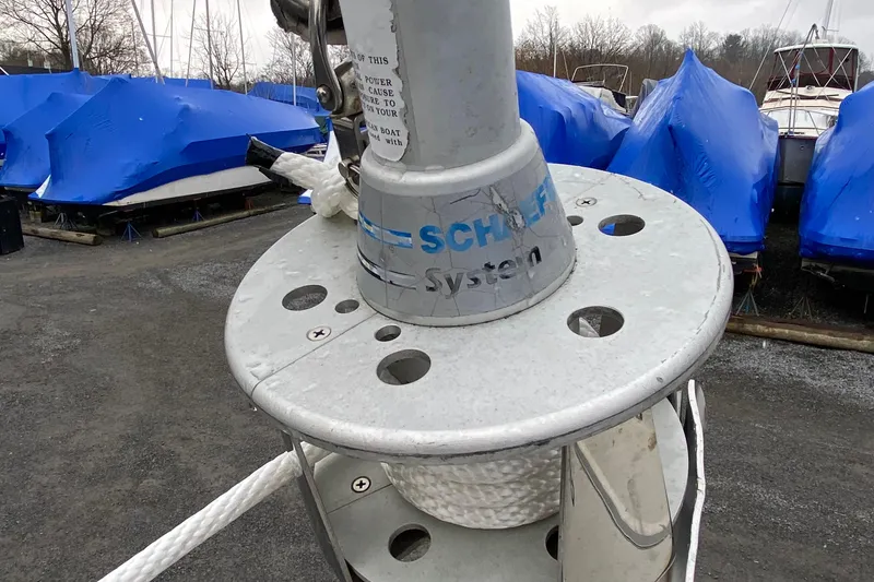 Slide: The Image of 1972 Bristol 40 sailboat with Schaefer system, covered in blue tarps at a boatyard. - 23