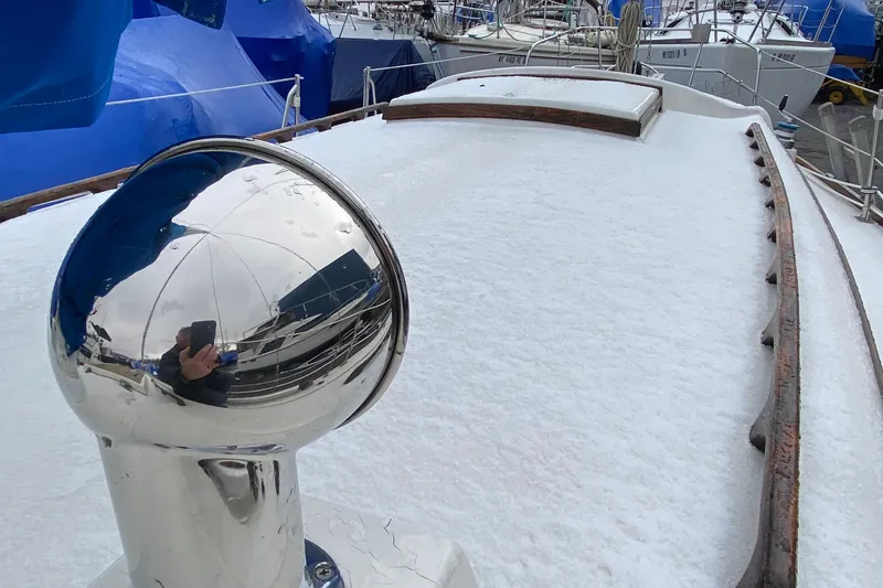 Slide: The Image of 1972 Bristol 40 yacht deck with snow and reflective metal fixture. - 26