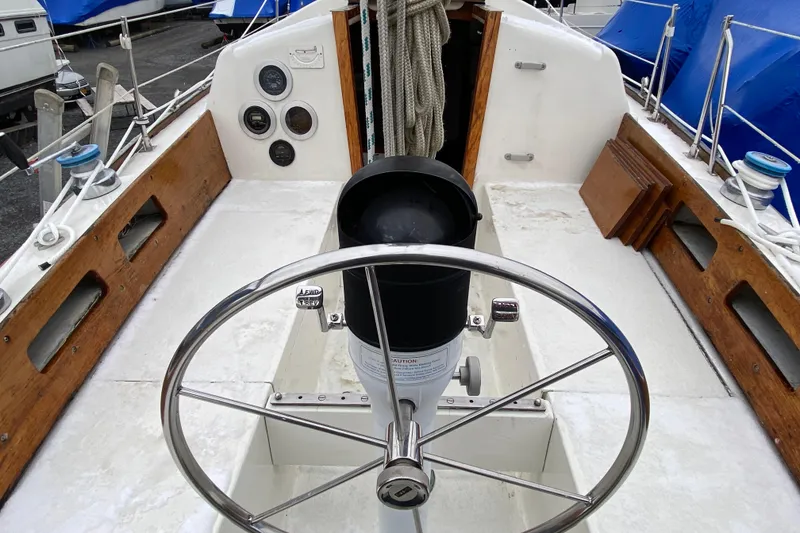 Slide: The Image of 1972 Bristol 40 sailboat cockpit with steering wheel and nautical instruments. - 28