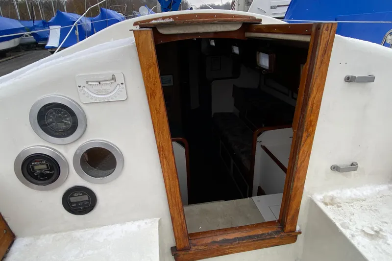 Slide: The Image of 1972 Bristol 40 sailboat cockpit with gauges and cabin entrance. - 32