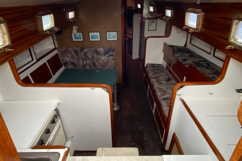 Slide: The Image of Interior of a 1972 Bristol 40 sailboat with cozy seating and wooden accents. - 33