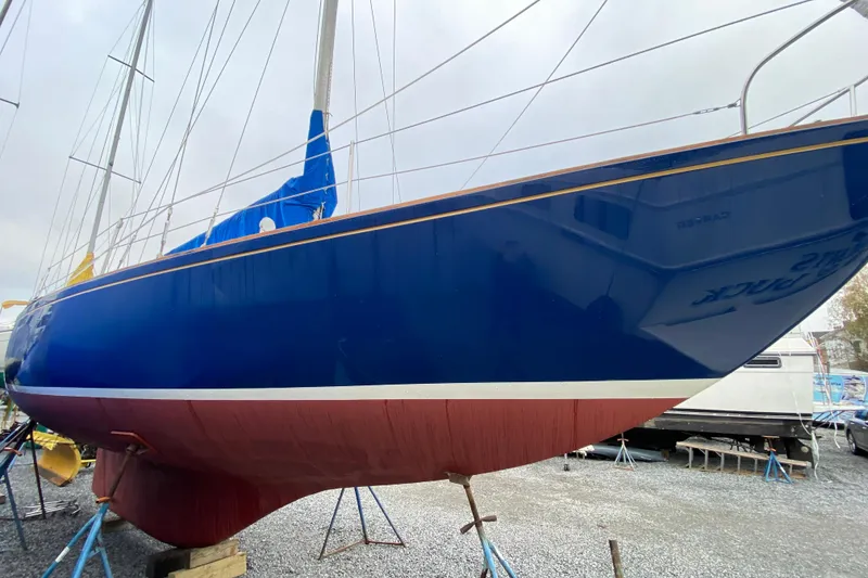 Slide: The Image of 1972 Bristol 40 sailboat with blue hull and red bottom on stands. - 4