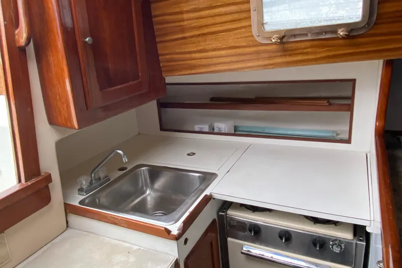 Slide: The Image of 1972 Bristol 40 yacht kitchen with sink, stove, and wooden cabinetry. - 42
