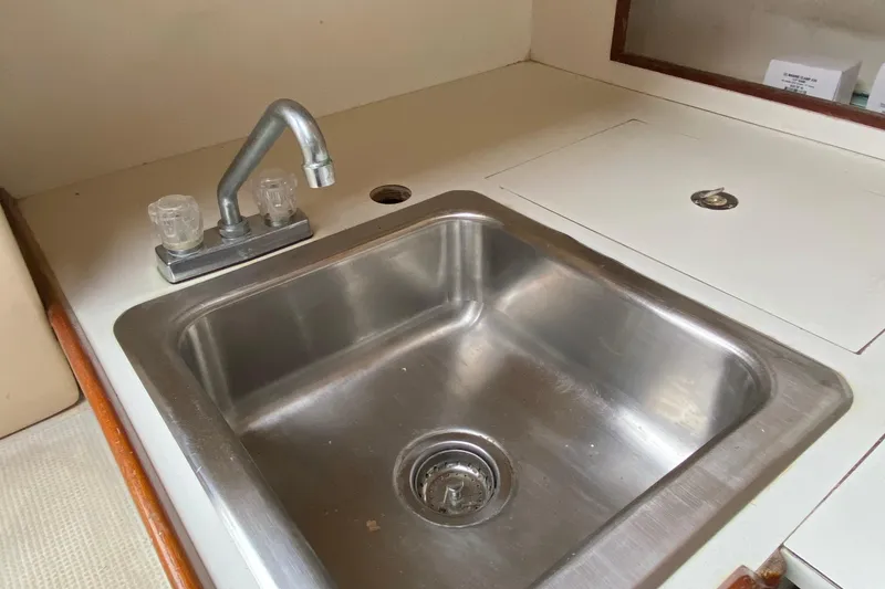 Slide: The Image of Stainless steel sink with dual-handle faucet in a 1972 Bristol 40 boat interior. - 43