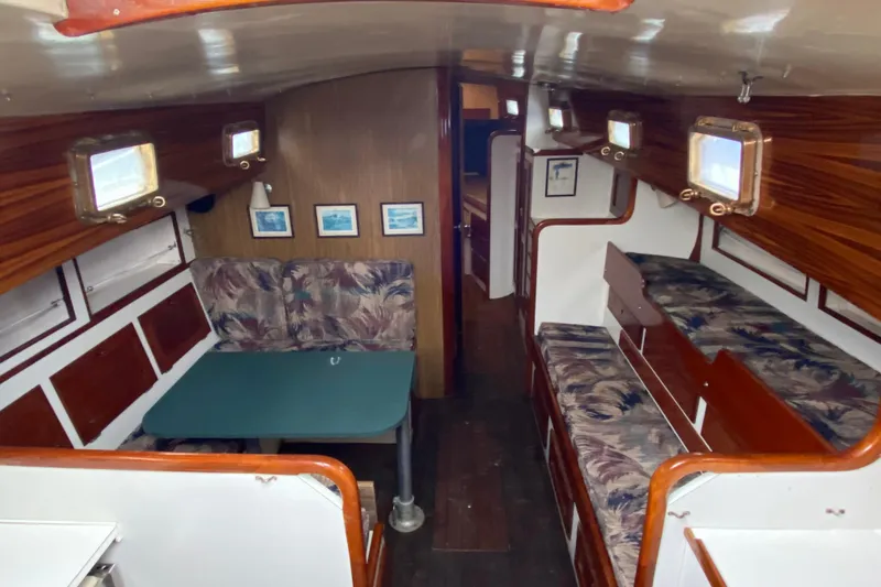 Slide: The Image of Interior of a 1972 Bristol 40 sailboat with cozy seating and wooden accents. - 45