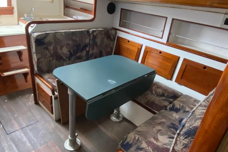 Slide: The Image of 1972 Bristol 40 interior with dining area, wooden cabinets, and floral upholstery. - 47