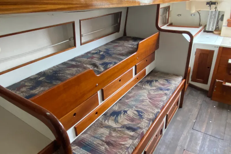 Slide: The Image of 1972 Bristol 40 interior with wooden bunk beds and patterned cushions. - 48