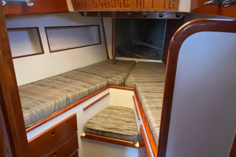 Slide: The Image of 1972 Bristol 40 sailboat interior with cushioned seating and wooden cabinetry. - 55