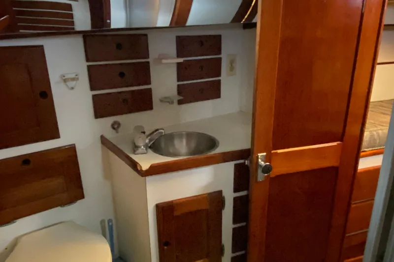 Slide: The Image of 1972 Bristol 40 yacht interior with wooden cabinetry and compact sink area. - 59