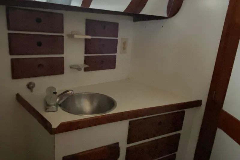 Slide: The Image of 1972 Bristol 40 yacht interior with sink and wooden storage drawers. - 60