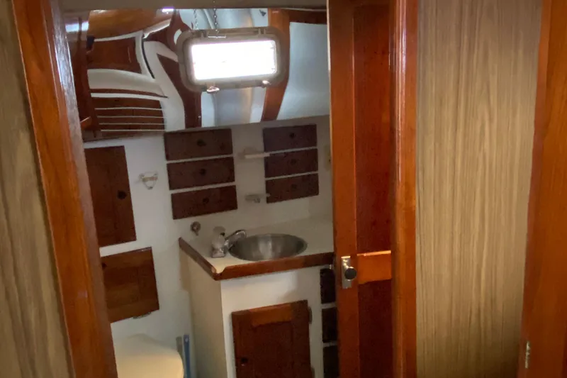 Slide: The Image of 1972 Bristol 40 yacht interior with wooden cabinetry and compact sink area. - 61