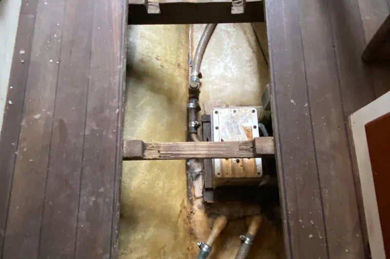 Slide: The Image of 1972 Bristol 40 interior showing plumbing and mechanical components under wooden floorboards. - 63