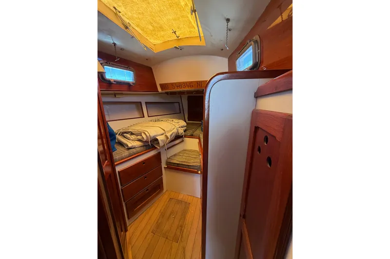 Slide: The Image of 1972 Bristol 40 yacht interior with wooden cabinetry and cozy sleeping area. - 64