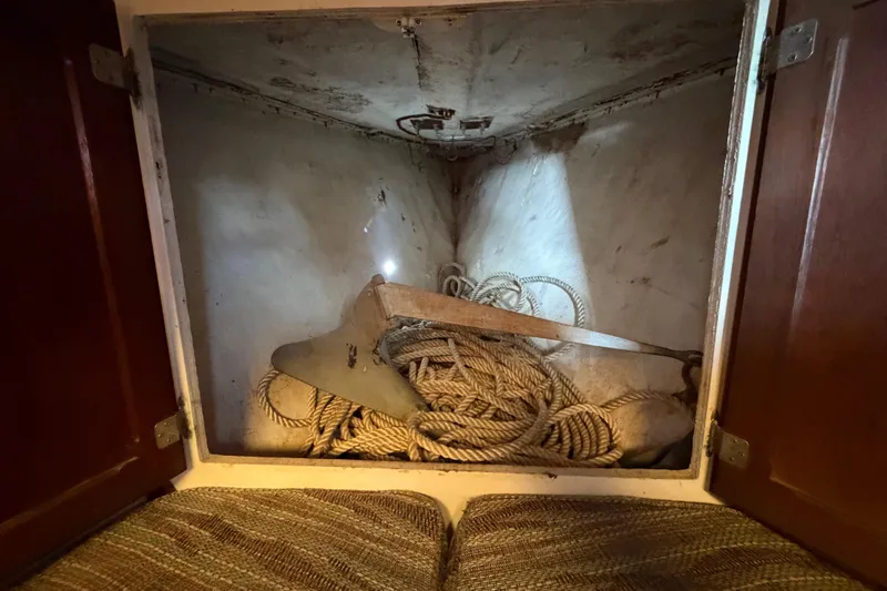 Slide: The Image of Storage compartment in a 1972 Bristol 40 sailboat with ropes and anchor. - 67