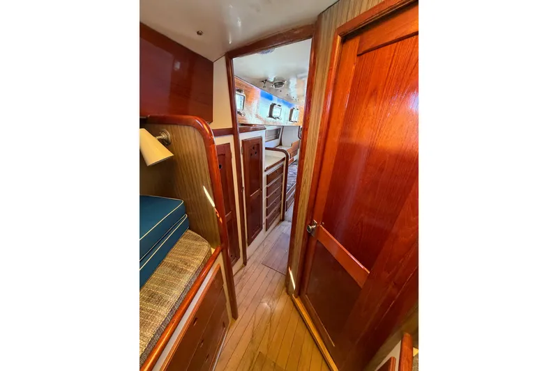 Slide: The Image of Interior of a 1972 Bristol 40 sailboat, featuring polished wood and cozy cabin space. - 68