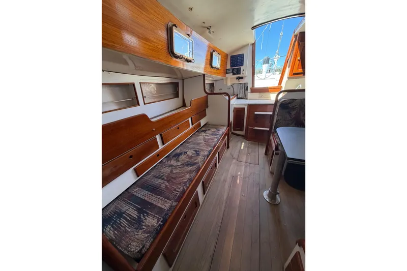 Slide: The Image of Interior of a 1972 Bristol 40 sailboat with wooden furnishings and seating. - 70