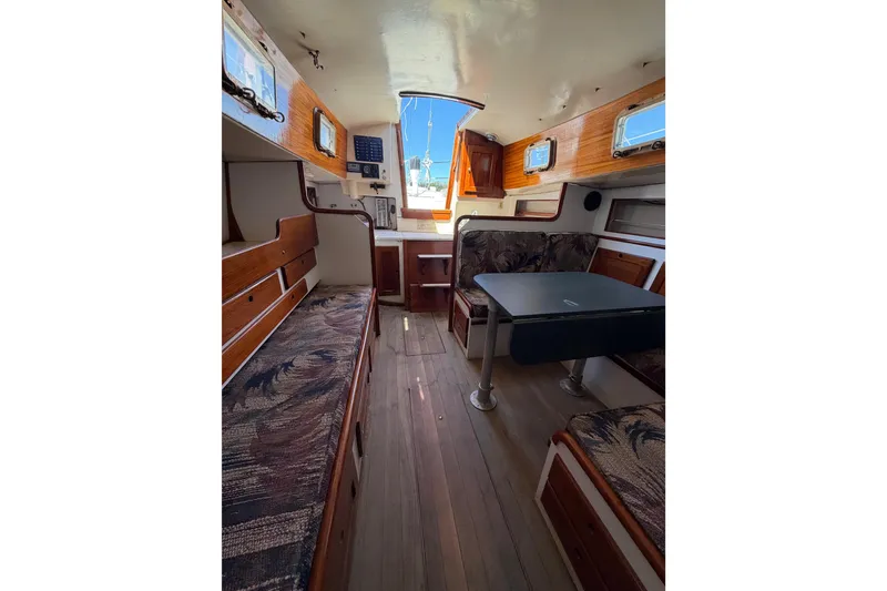Slide: The Image of Interior of a 1972 Bristol 40 sailboat with wooden accents and seating area. - 72