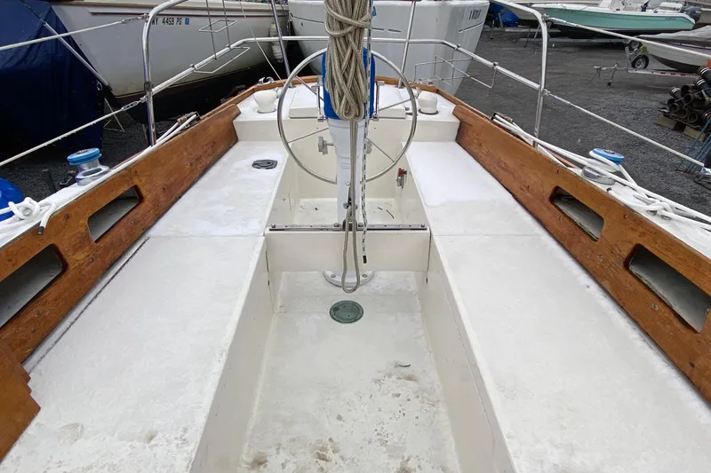 Slide: The Image of 1972 Bristol 40 sailboat cockpit with wooden trim and steering wheel. - 9