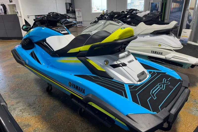 Slide: The Image of 2023 Yamaha WaveRunner FX Cruiser HO in showroom, vibrant blue and yellow design. - 5