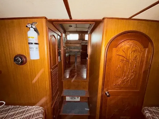 Slide: The Image of 1981 CHB 34 Tri-Cabin yacht docked, featuring wooden details. - 36