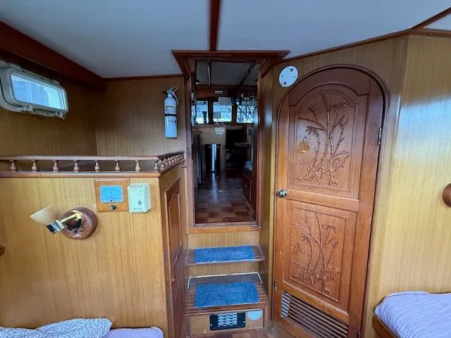 Slide: The Image of 1981 CHB 34 Tri-Cabin boat docked with dinghy. - 38