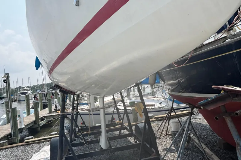 Slide: The Image of 1993 J Boats J/80 sailboat on stands at a marina, under maintenance. - 12