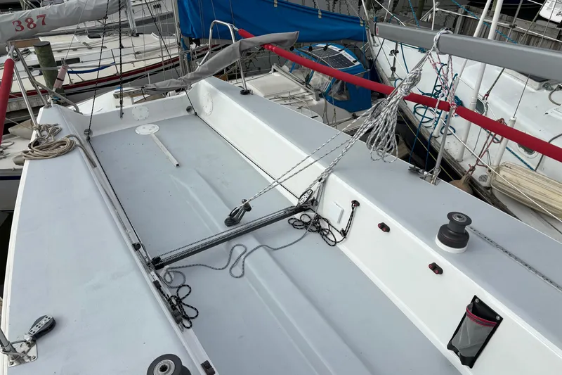 Slide: The Image of 1993 J Boats J/80 sailboat deck with rigging and winches in marina setting. - 15