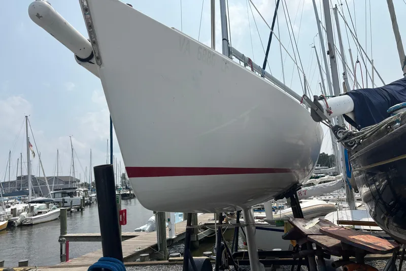 Slide: The Image of 1993 J Boats J/80 sailboat docked at a marina, viewed from the bow. - 4