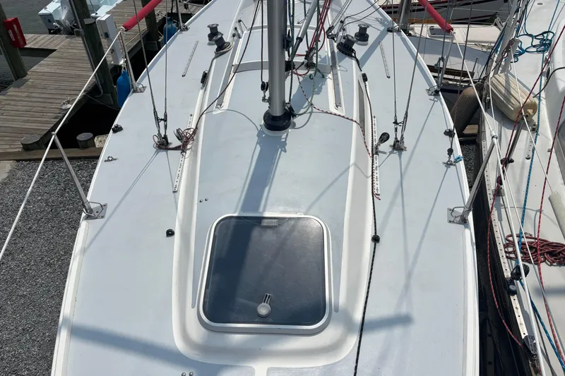 Slide: The Image of 1993 J Boats J/80 sailboat deck with rigging and hatch, docked at marina. - 5