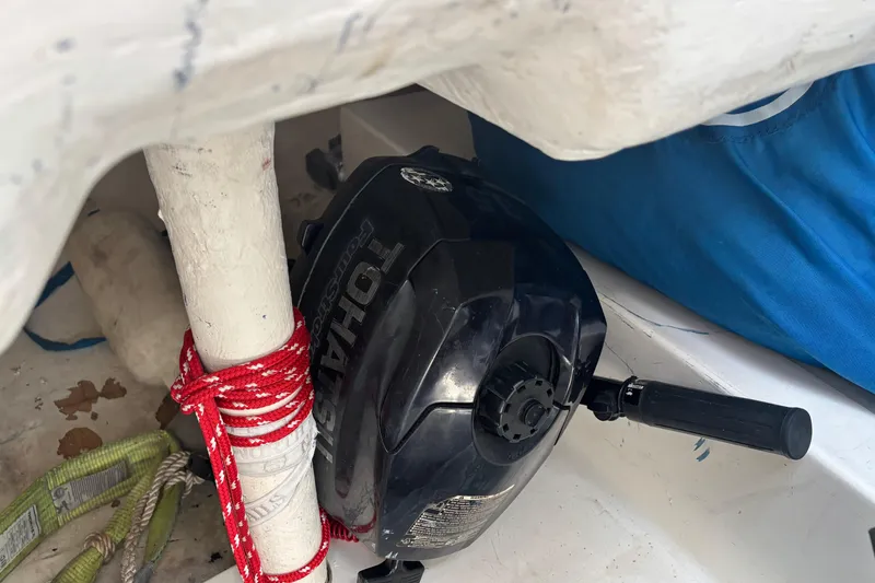 Slide: The Image of Tohatsu outboard motor in a 1993 J Boats J/80 sailboat, secured with red rope. - 8