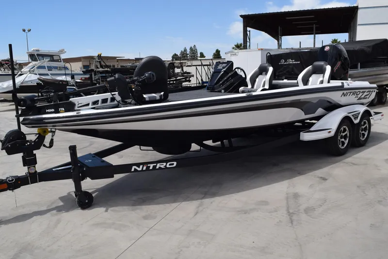The Image of 2026 Nitro Z21 XL Pro boat on trailer, sleek design, parked outdoors. - 0