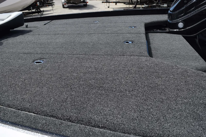 Slide: The Image of 2026 Nitro Z21 XL Pro boat deck with gray carpet and storage compartments. - 10