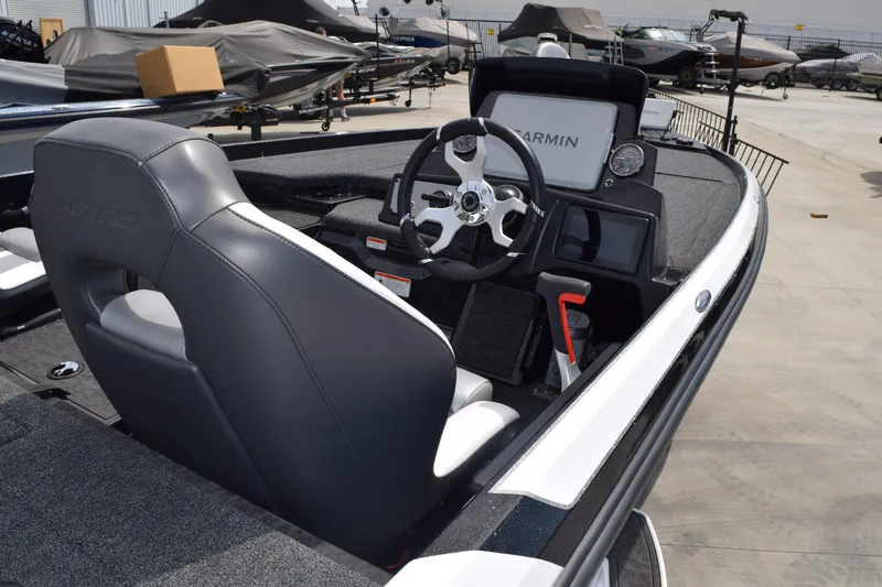 Slide: The Image of 2026 Nitro Z21 XL Pro boat interior with Garmin navigation system and sleek steering wheel. - 2