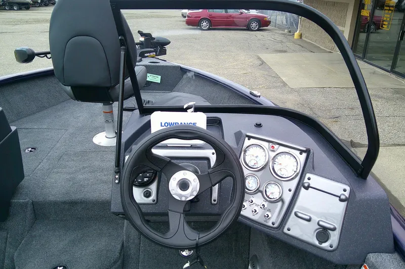 Slide: The Image of 2026 Tracker Pro Guide V-175 WT boat interior with steering wheel and dashboard controls. - 4
