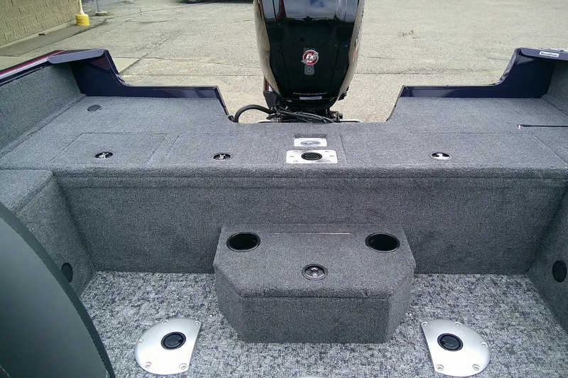 Slide: The Image of 2026 Tracker Pro Guide V-175 WT boat interior with motor, featuring carpeted deck and storage compartments. - 6