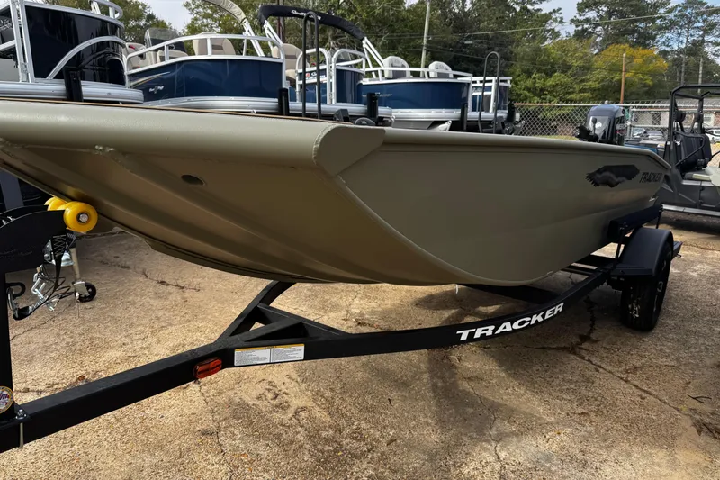 The Image of 2026 Tracker Grizzly 1650 T Prairie Wings Edition boat on trailer, parked outdoors. - 0