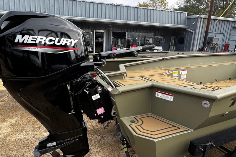Slide: The Image of 2026 Tracker Grizzly 1650 T Prairie Wings Edition boat with Mercury engine at dealership. - 29