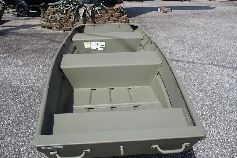 Slide: The Image of 2026 Tracker Grizzly 12 Jon boat on pavement, showcasing interior seating and design. - 10