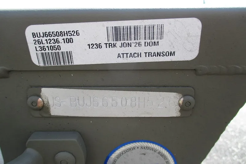 Slide: The Image of 2026 Tracker Grizzly 12 Jon boat transom with identification labels and serial numbers. - 11