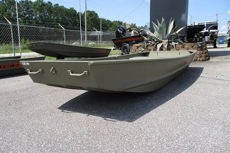 Slide: The Image of 2026 Tracker Grizzly 12 Jon boat displayed outdoors on pavement. - 5