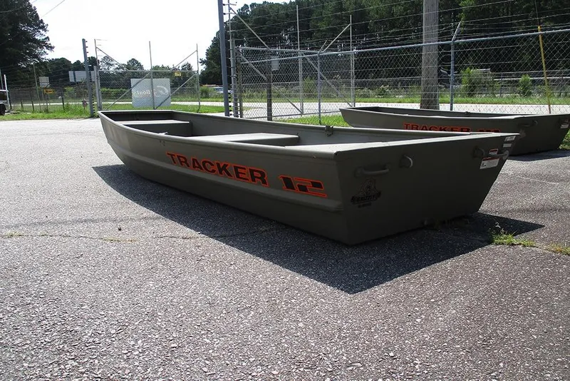 Slide: The Image of 2026 Tracker Grizzly 12 Jon boat in outdoor setting, showcasing durable design. - 7