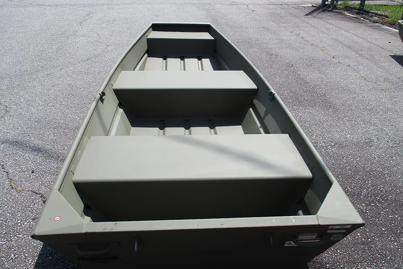 Slide: The Image of 2026 Tracker Grizzly 12 Jon boat on pavement, showcasing interior seating and design. - 9