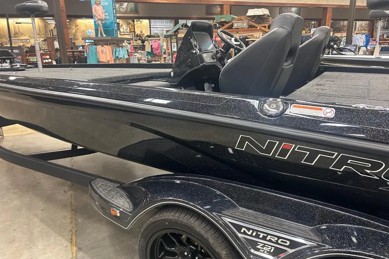 Slide: The Image of 2026 Nitro Z21 XL Pro boat displayed indoors, featuring sleek black design and modern seating. - 83